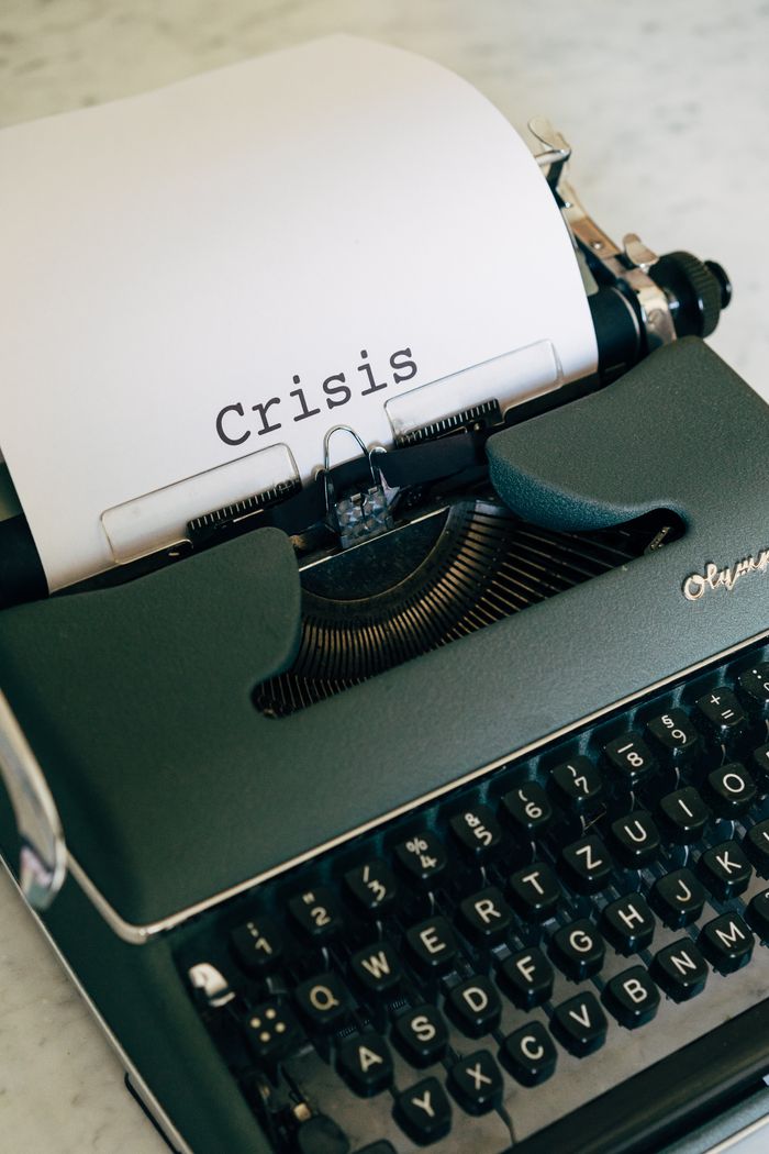 services-bg Close-up of a vintage typewriter with the word Crisis typed on paper.