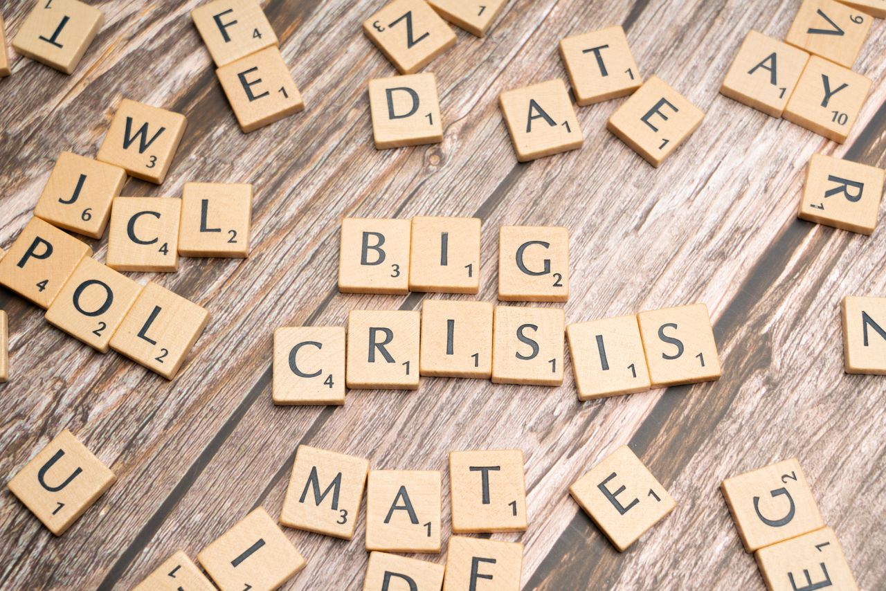 services-01 Wooden tiles forming the words Big Crisis on a wooden background.